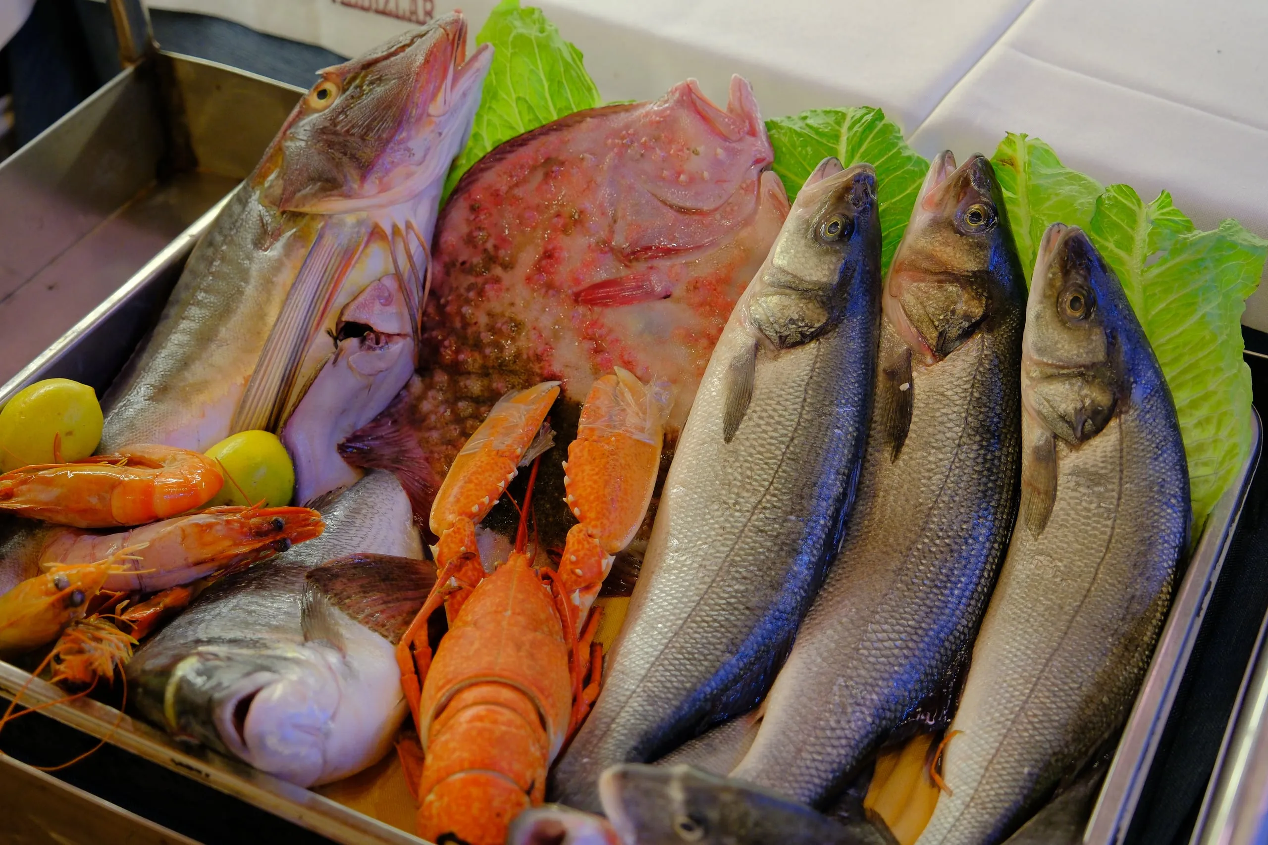 Fish display on ice with sea bass, sea bream, red mullet and lobster