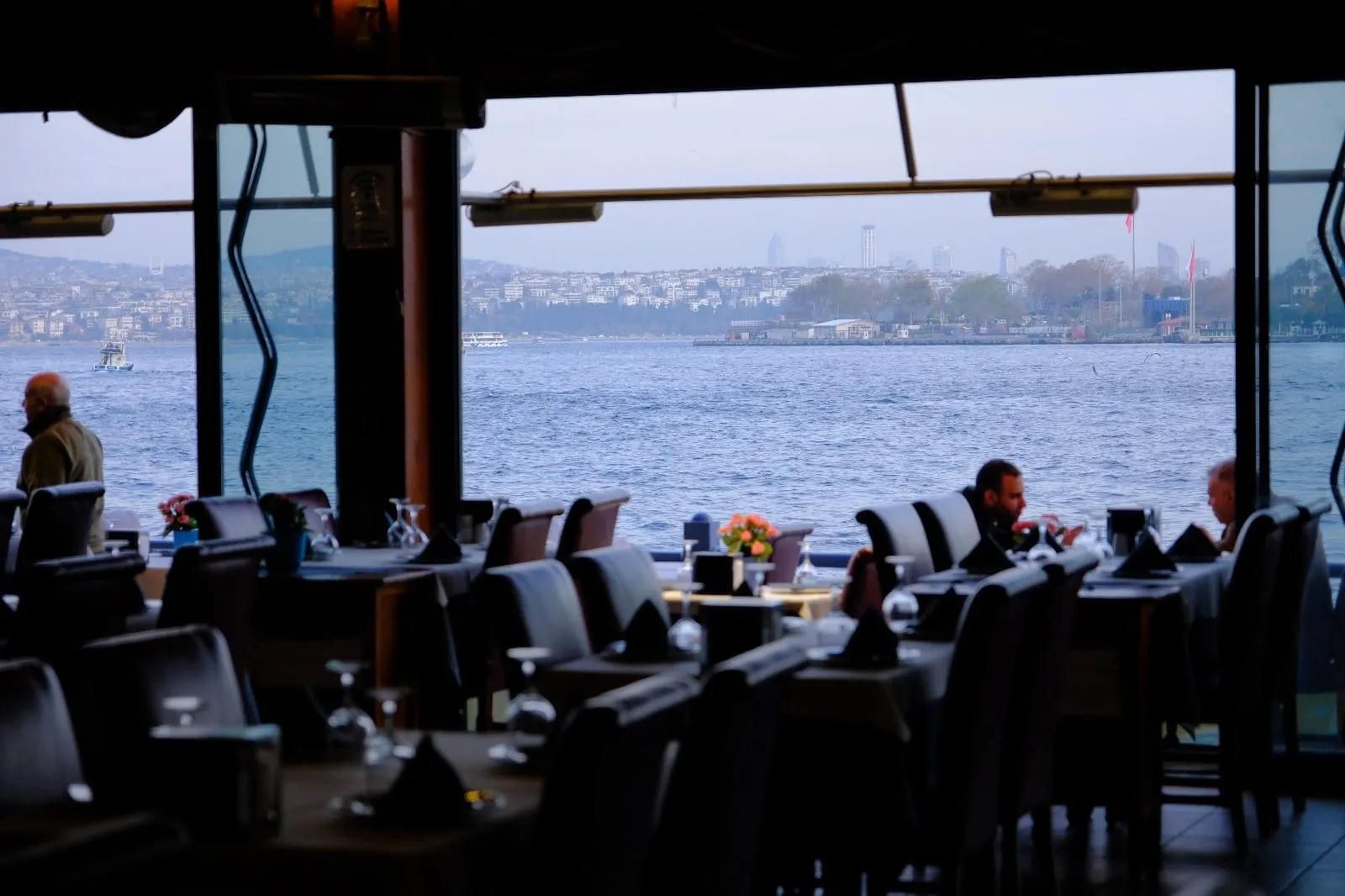 Window-side tables and the sea in the early evening