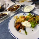 A guest’s plate: shrimp, roasted aubergine, haydari and salad, with meze on the side